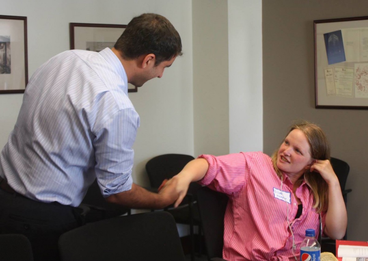 Featured advocate Lisa Sawyer greets Washington State Rep. Brady Walkinshaw at a meeting of  the Washington Low Income Housing Alliance's Emerging Advocates Program. Photo credit: WLIHA.